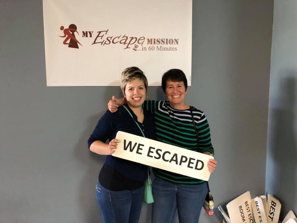 Caitlin and Me holding sign that reads "We Escaped" at My Escape Mission