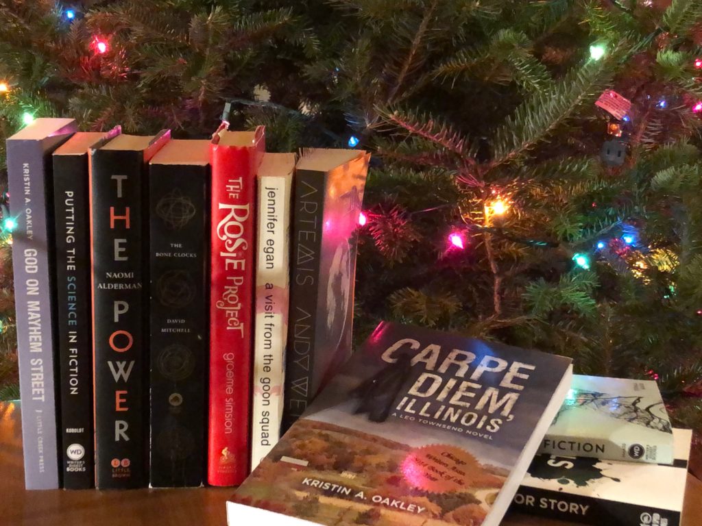 Books stacked by Christmas tree lights