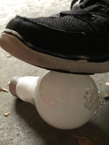 Sneaker stepping on lightbulb