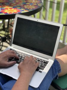 Kristin writing on her computer