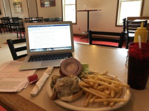 Plate of burger and fries and Kristin's computer at Tofflers Pub & Grill