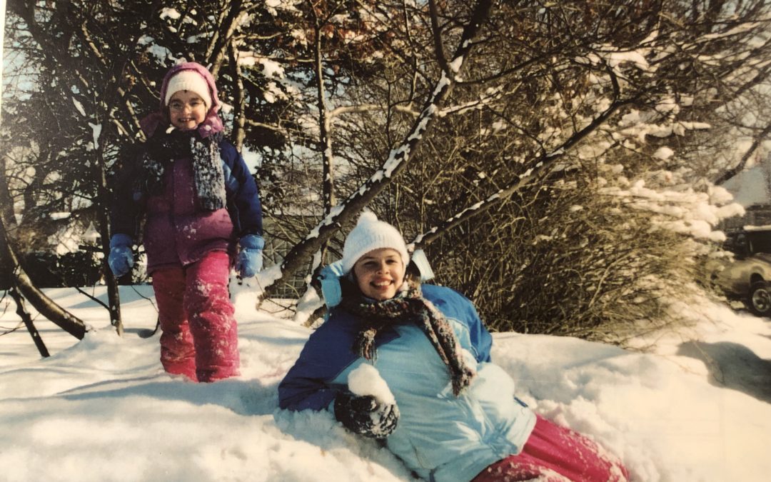 Kristin's daughters climbing on a snow bank