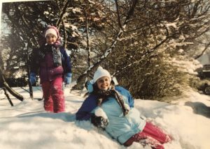 Kristin's daughters climbing on a snow bank