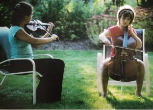 Caitlin and Jessica playing the violin and cello in our backyard