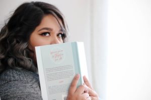 Girl holding a book to her face