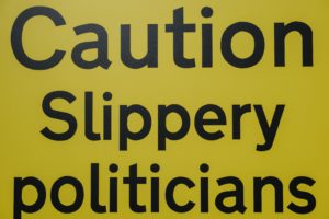 Sign that says "Caution Slippery politicians"