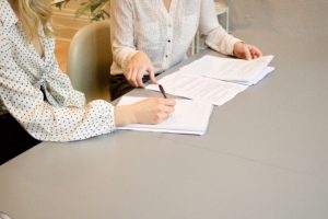 Two women working on pages