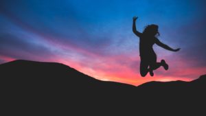 Jumping for joy during a sunset