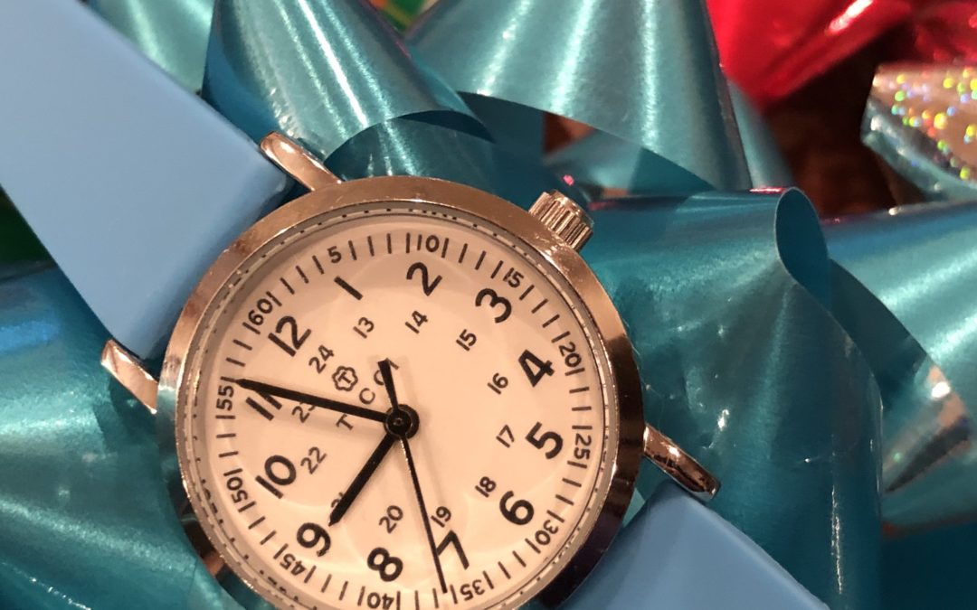 A watch laying on Christmas bows