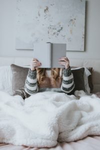 A young women in bed reading