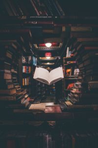 Book floating in circle of stacked books