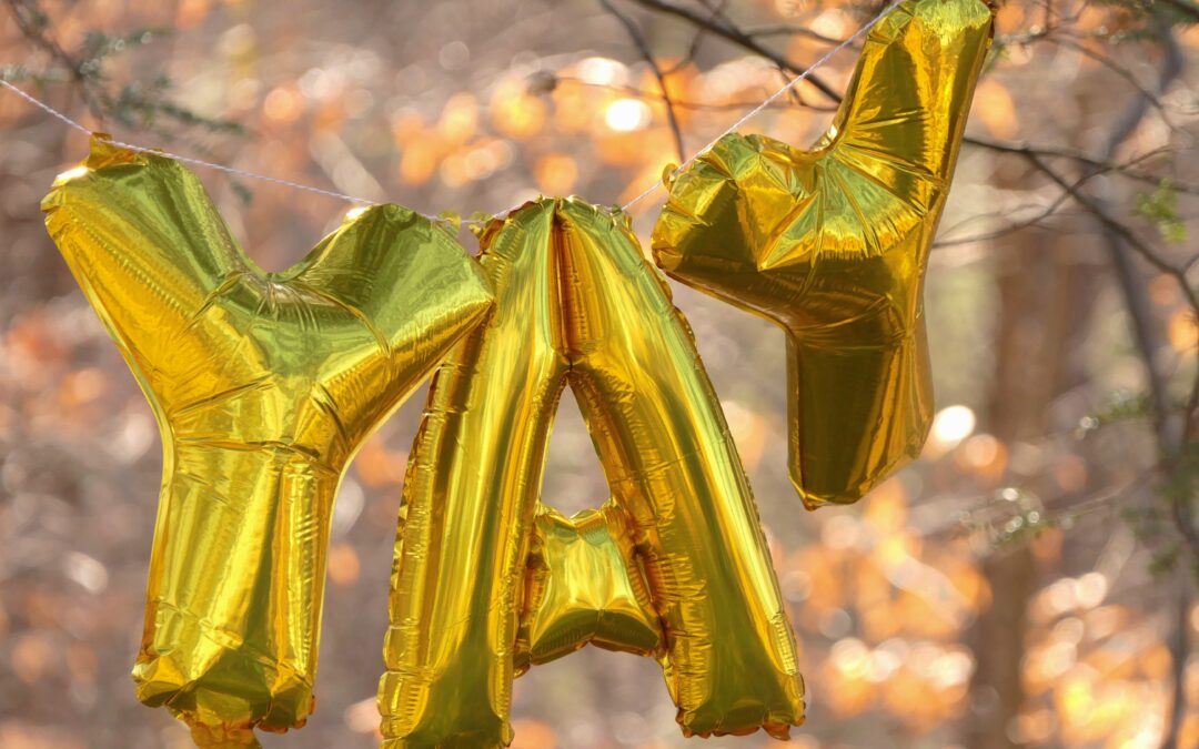Gold balloons that spell out "YAY"