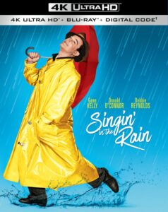 Gene Kelly in a yellow raincoat and red umbrella in the rain