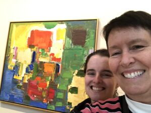 Jessica and Kristin in front of a modern painting
