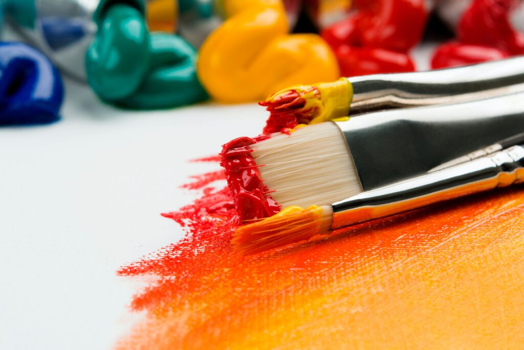 Colorful paints with brushes