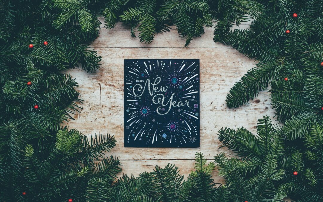 New Year sign surrounded by evergreens